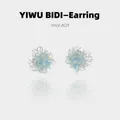 Detailed macro shot of blue flower earrings with gold glitter and silver needles - Light Blue Gradient Transparent Flower Studs (21#)