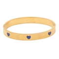 Detailed close-up of golden vintage heart bangle with blue enamel and floral engraving - Sapphire Blue