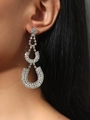 Elegant long silver rhinestone dangle earrings with geometric drop design on female model - Silver Horseshoe Pendant Style (DTE1616617S)