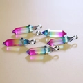 Rainbow gradient hexagonal crystal pendants with polished metal clasps set on beige background - Rainbow Ombre