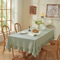 Light green washed cotton tablecloth with ruffled edges on a rectangular table in a warm room - Light Green Lotus Flowers