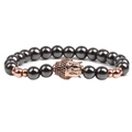 Macro view of hematite stone beads with a rose gold pavé Buddha charm detailing - Rose Gold Buddha Head