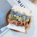 Velvet hair scrunchies set in cream, dusty blue, and green on a wooden tray - White Green