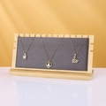 Bamboo necklace display stand with grey velvet pad and elegant golden jewelry - Grey / Velvet