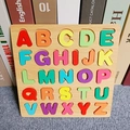 Macro view of wooden alphabet puzzle board with colorful A-Z 3D capital letters - Square Alphabet Board