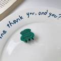 Emerald green acetate mini hair claw clip with heart cutout on a decorative plate - Green and Black