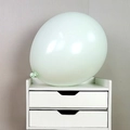 Light green latex balloon with matte texture placed on a white mini drawer cabinet - 18 Inch Macaron Green