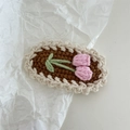 Detailed knit texture of a brown crochet clip with a pink tulip and white wave borders - Crochet-Pink Flower Bouquet