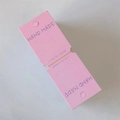 Detail of pink handmade paper tag with Hand Made text and pre-punched hanging hole - 5*14cm / Pink
