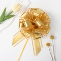 Golden snow gauze pull bow for gift wrapping with metallic gold stripes and ribbons - Gold
