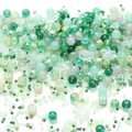 Mix of mint green and purple glass beads in starfish and fish shapes for DIY jewelry - Xizi Green