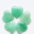 Polished light green quartz heart-shaped crystal stones arranged in a circle - Green Aventurine