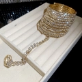 Close-up of gold plated rhinestone hand chain with multi-layer wrap bracelet and ring - Gold