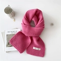 Pink chunky knit scarf styled with a ceramic mug and book on a clean white surface - Rose Red