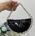 Detail of black sequined crescent bag with large crystal handle for evening parties - Black Round Sequin