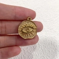 Macro detail of golden stainless steel coin pendant featuring embossed evil eye design - 2 Irregular Round Eye