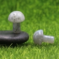 Pair of 2cm mini mushroom-shaped natural dalmatian stones on green grass background - Labradorite