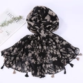 Detailed flat lay of black beach shawl with beige floral pattern and tassel edges - Style 6