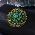 Vintage gold brooch with green crystals in floral design on textured background - Deep Green & Olive Green with Peacock Green Acrylic Retro Round