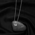 Silver Leo zodiac necklace with dainty cross chain over a dark silk and stone backdrop - Leo Steel
