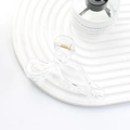 Elegant transparent bow hair claw clip with golden spring on a white textured tray - Clear
