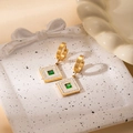 Detail of golden square earrings with green stone and white enamel on ceramic tray - Crystal Square Earrings
