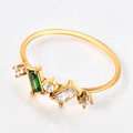 Macro shot of gold ring with emerald-cut green gemstone and cubic zirconia details - US 6 / Double Stone