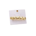 Elegant golden alloy hair clip with spherical design on a white branded card - Gold Liquid Circle