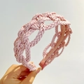 Close-up of pink braided PU leather headband showing intricate woven texture and detail - Pink