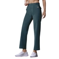 Detail view of dark blue straight leg cropped jeans with waist buckle and white sneakers - Blue