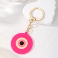 Portachiavi con occhio magico rosa in acrilico con anello dorato e design geometrico - Occhio del Male Rosso Rosa