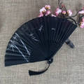 Traditional black folding fan with bamboo dragonfly motifs and a decorative tassel - No.35 Black Ink Bamboo Dragonfly