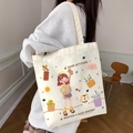White canvas tote bag with cute cartoon girl and dog illustration worn by model - Sunshine Girl