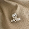 Elegant cream marble acetate hair claw clip with a glossy finish on beige fabric - Beige Grey