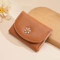 Caramel brown tri-fold wallet in lychee faux leather with a 3D daisy flower design - Tan