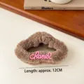 Brown plush hair clip with pink Chanel logo text, soft faux fur accessory for women - Coffee Plush Letter Hair Claw