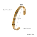 Detail view of 6mm gold stainless steel open bangle with blue and red enamel patterns - Gold + Mountain (B037)