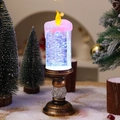 Detalle de vela de agua navideña con base de bronce y luz LED que cambia de color vibrante - Degradado de Oro Cepillado