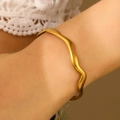 Detail of matte gold irregular wave cuff bracelet on wrist with elegant satin finish - Irregular Wave (Matte)