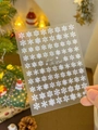Detail showing white embossed snowflake nail stickers with Ice and Snow World text - 5D Relief White Snowflake YT3742