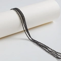 Faceted black zircon crystal beads for DIY jewelry making on a white cylinder stand - 2mm / Black