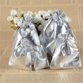 Multiple sizes of silver metallic drawstring jewelry pouches on decorative background - 5x7cm / Silver
