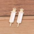 Golden alloy syringe charms for medical jewelry DIY crafts on wood background - Large Syringe / Gold/White
