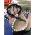 Black and multicolor beaded magnetic couple bracelets held in hand showing connection - Amazonite with Matte B Style (亚马逊/磨砂B)