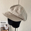 Beige cotton octagonal newsboy hat with visible stitching on a professional head model - Beige