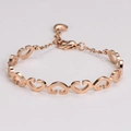 Detailed macro view of rose gold interlocking heart links on the adjustable bracelet - Rose Gold