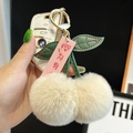 Cute cherry plush keychain with off-white faux fur balls and green leather leaves - White Cherry Because Of You