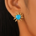 Macro shot of a vintage golden sun-shaped earring with a blue heart center on a model - Blue Sun (Z-056)