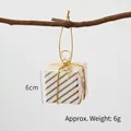 Mini gold and white striped Christmas gift box ornament with gold string hanging on tree - Gold Striped