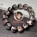 Macro detail of 15mm carved lotus bodhi seed beads on a handmade beaded bracelet - Bodhi Carved Lotus Single Loop